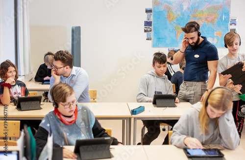 Children in classroom using digital tablet, Sweden photo