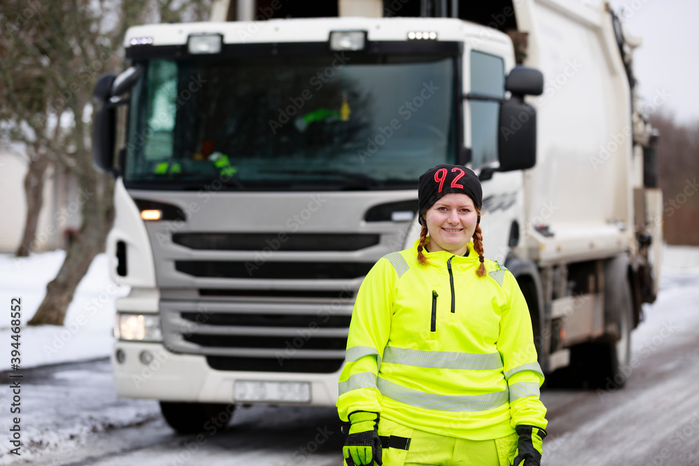 Woman standing in front of garbage truck, Sweden Woman standing in front of garbage truck, Sweden