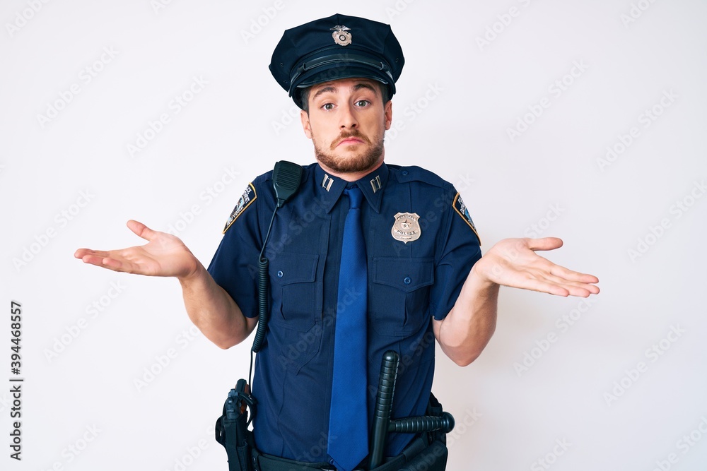 Young caucasian man wearing police uniform clueless and confused with open arms, no idea concept. Young caucasian man wearing police uniform clueless and confused with open arms, no idea concept.
