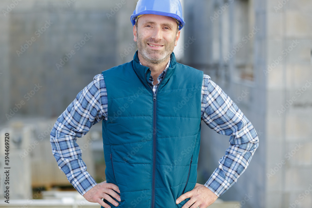a male builder standing outdoors a male builder standing outdoors