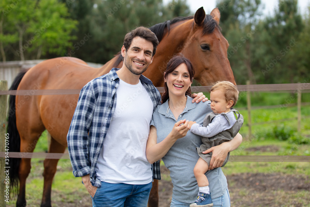 young family with child on an equestrian ranch