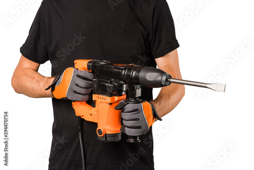 Obraz na płótnie Man hold orange perforator drill at studio