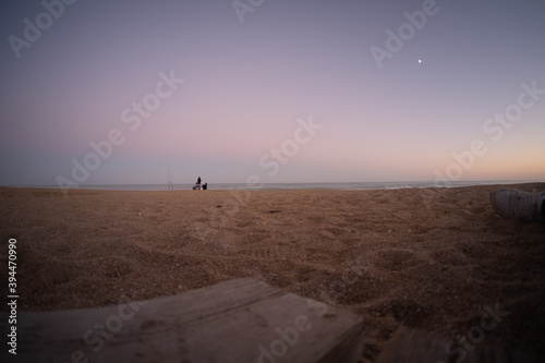  Landscape of the beach from the sand in autumn at sunset.