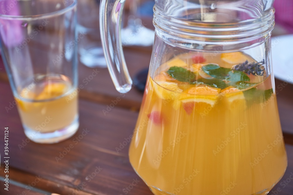Serving fresh lemonade in a jug in a restaurant Serving fresh lemonade in a jug in a restaurant