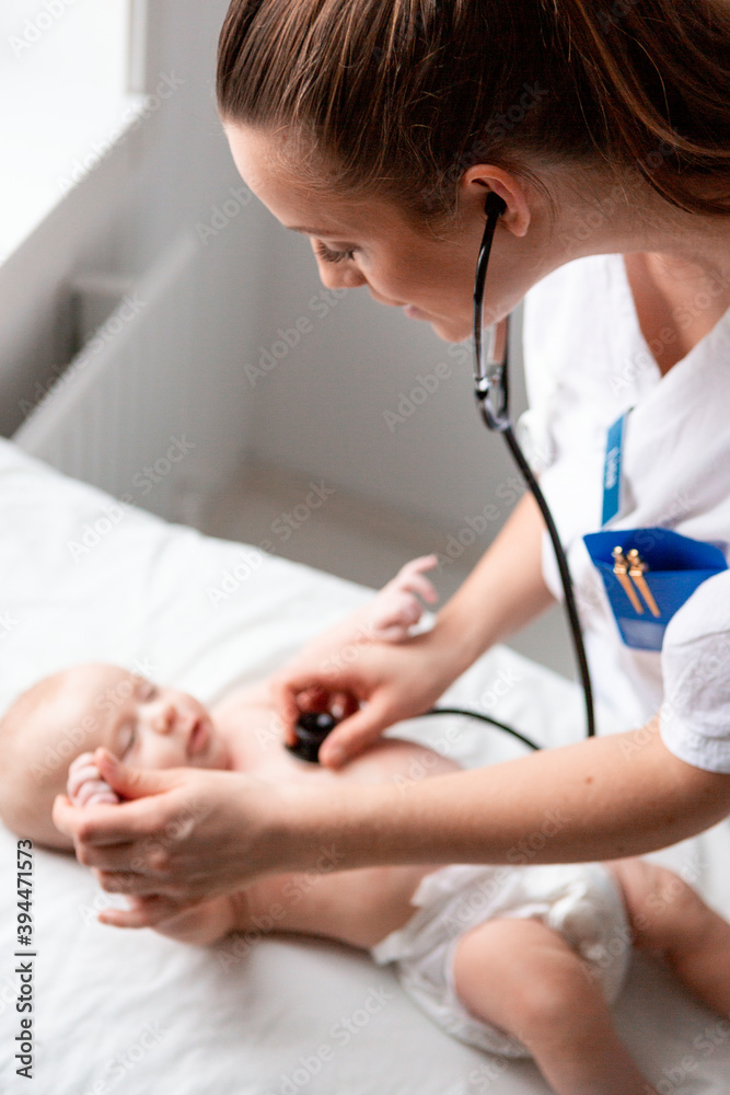 Female doctor examining baby, Sweden Female doctor examining baby, Sweden