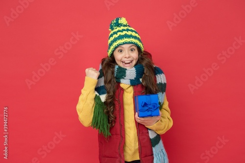 happy childhood. teen girl hold box. knitted clothing style. new year holiday. cheerful child wear warm winter clothes. successful seasonal shopping sales. buy presents and gifts for christmas