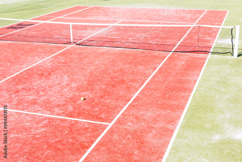 Fototapeta premium High angle view of empty red tennis court on sunny day