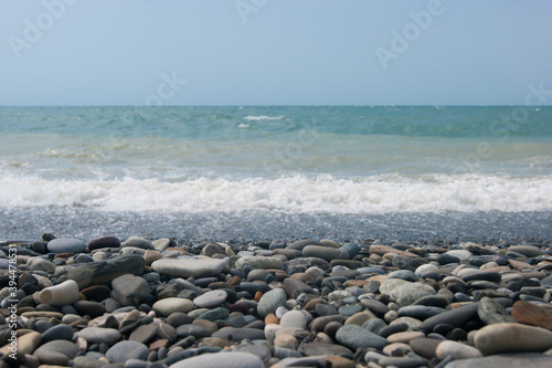 A small storm three or four points at sea, the wave hits the shore with a large pebble. Black Sea, summer vacation vacation beach travel
