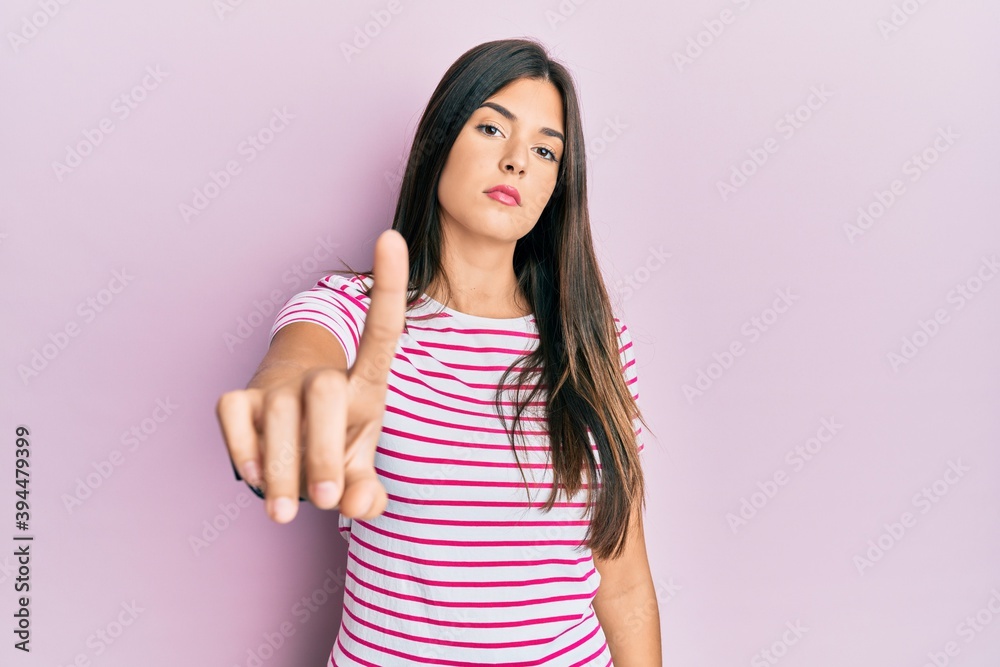 Young brunette woman wearing casual clothes over pink background pointing with finger up and angry expression, showing no gesture Young brunette woman wearing casual clothes over pink background pointing with finger up and angry expression, showing no gesture