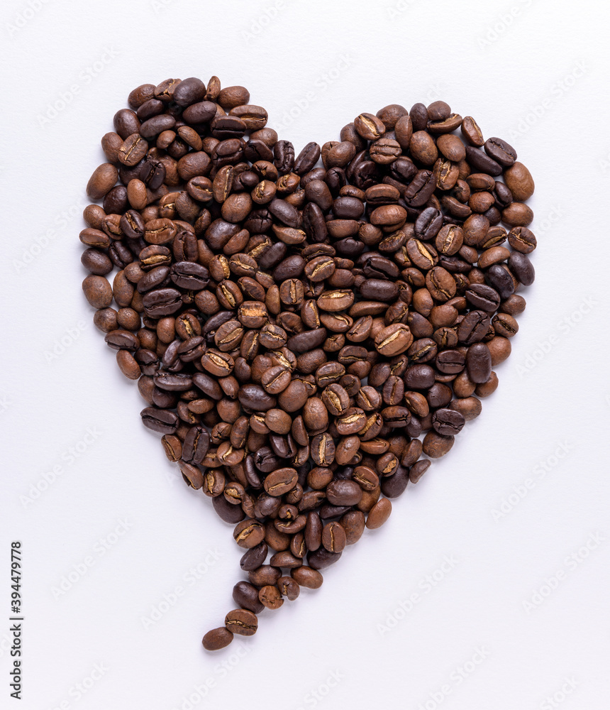 Pointy heart shape made out of coffee beans on a white background Pointy heart shape made out of coffee beans on a white background