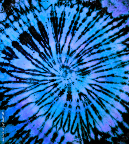 Reverse spiral tie dye in blue. Hippie tie-dye pattern texture background wallpaper.