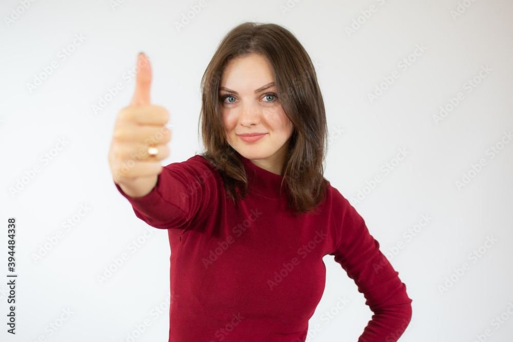 Happy young woman giving thumb up on white background Happy young woman giving thumb up on white background