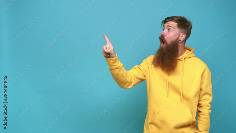 Young adult bearded caucasian man isolated pointing to the side Young adult bearded caucasian man isolated pointing to the side