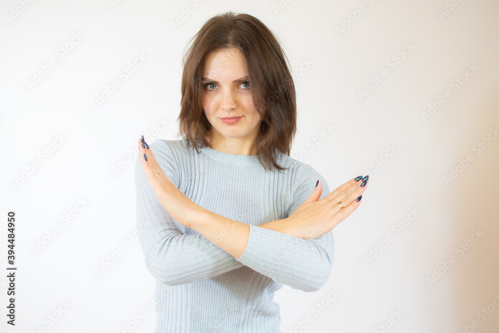 Young beautiful caucasian woman doing stop gesture with the hands. Warning expression with negative and serious gesture on the face isolated over white background. Young beautiful caucasian woman doing stop gesture with the hands. Warning expression with negative and serious gesture on the face isolated over white background.
