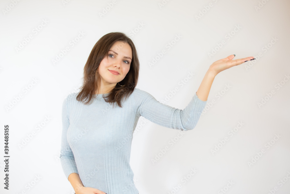 Young woman over isolated white background holding copy space imaginary on the palm to insert an ad Young woman over isolated white background holding copy space imaginary on the palm to insert an ad