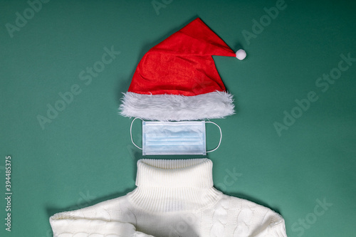 red hat mask and white sweater flat lay shape of Santa Slaus photo