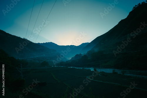 sunset sunrise in the morning misty green mountain valley.