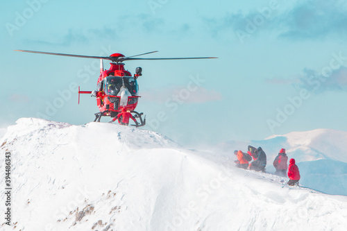 A rescue helicopter landing in the snow Swiss alps 