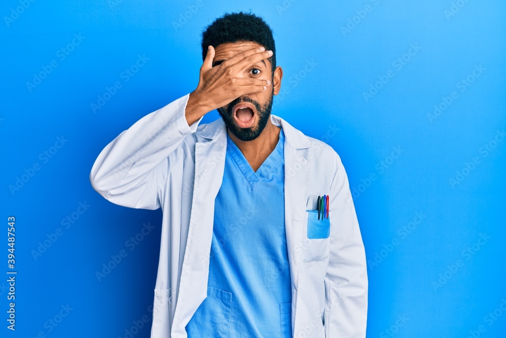 Handsome young hispanic business man wearing doctor uniform looking at the camera smiling with open arms for hug. cheerful expression embracing happiness. Handsome young hispanic business man wearing doctor uniform looking at the camera smiling with open arms for hug. cheerful expression embracing happiness.