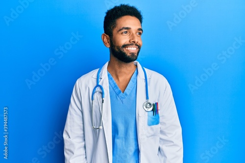 Handsome young hispanic man wearing doctor uniform and stethoscope feeling unwell and coughing as symptom for cold or bronchitis. health care concept.