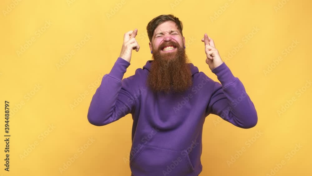 Young adult bearded caucasian man isolated crossing fingers for having luck Young adult bearded caucasian man isolated crossing fingers for having luck
