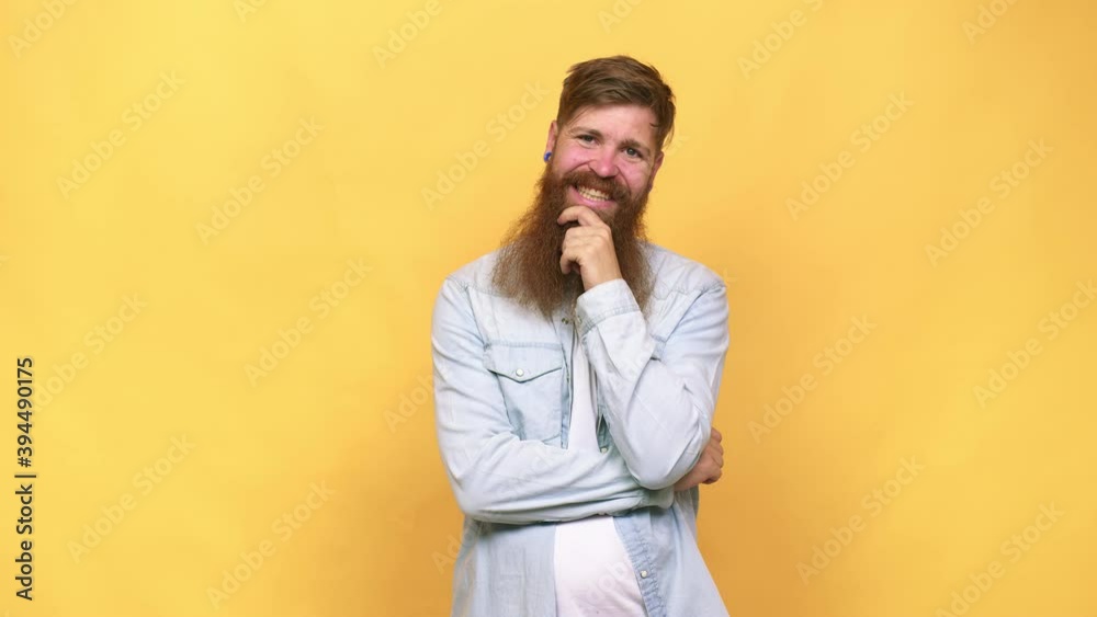 Young adult bearded caucasian man isolated smiling happy and confident, touching chin with hand Young adult bearded caucasian man isolated smiling happy and confident, touching chin with hand