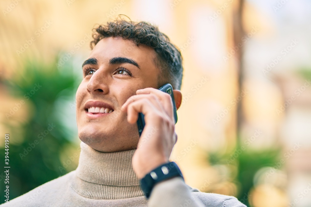 Young hispanic man smiling happy talking on the smartphone at the city. Young hispanic man smiling happy talking on the smartphone at the city.
