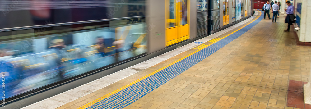 Fototapeta premium SYDNEY, AUSTRALIA - NOVEMBER 6, 2015: Fast moving subway train in the city center