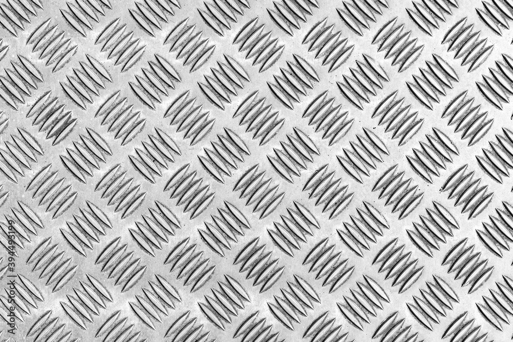 Patterned silver steel sheet for flooring texture and seamless background Patterned silver steel sheet for flooring texture and seamless background