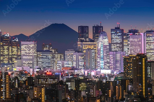 Wall Mural Tokyo night atmosphere There are tall buildings in Shinjuku and Mount Fuji