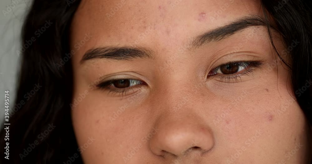 Pensive thoughtful Hispanic girl close-up face eyes thinking deeply Pensive thoughtful Hispanic girl close-up face eyes thinking deeply
