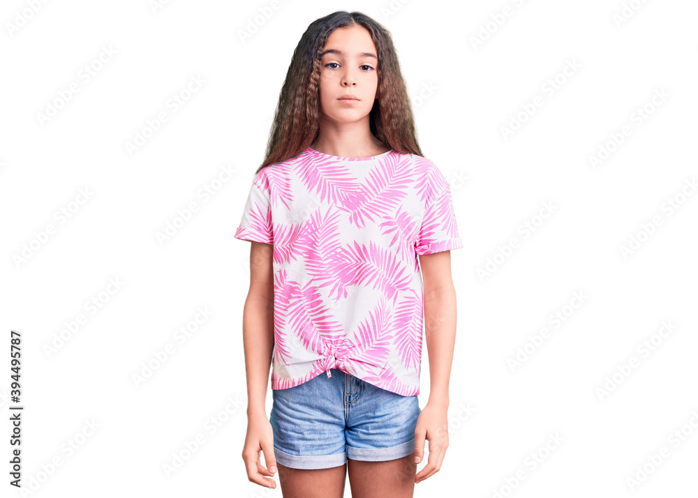 Obraz premium Cute hispanic child girl wearing casual clothes relaxed with serious expression on face. simple and natural looking at the camera.