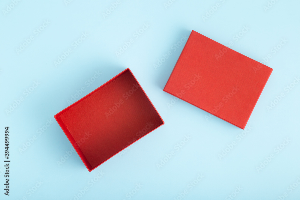Gift box open with lid isolated on blue background.