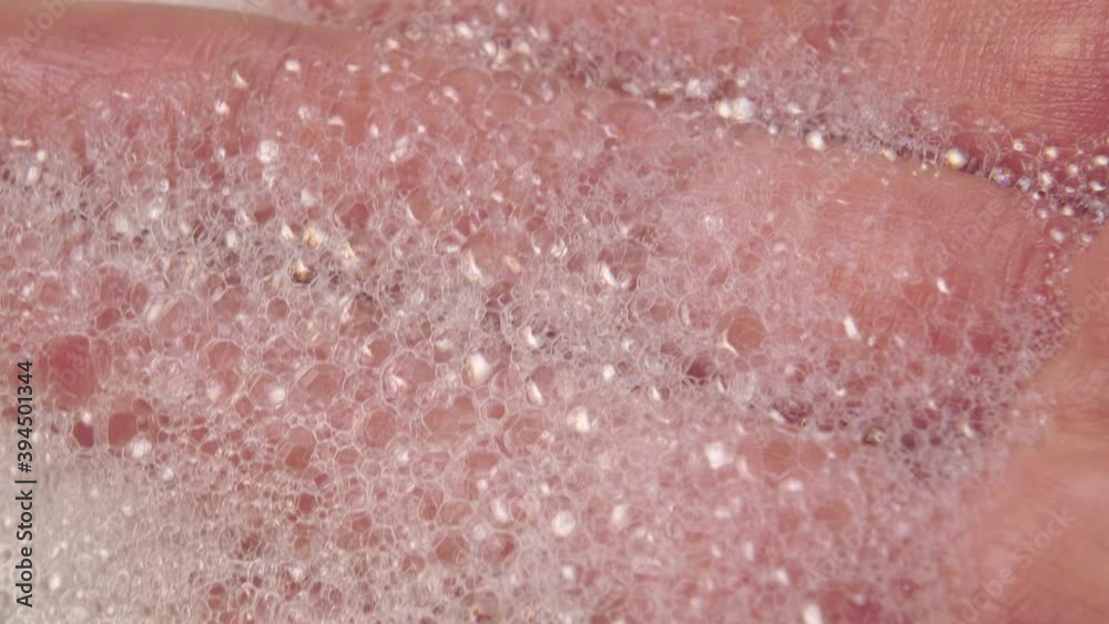 Foam on hand macro shot. Close-up bubbles on the palm and fingers. Selective focus Foam on hand macro shot. Close-up bubbles on the palm and fingers. Selective focus
