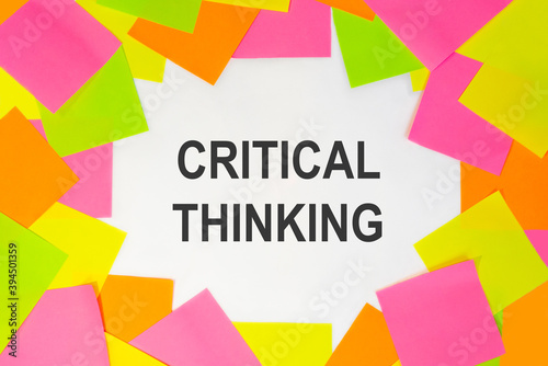 Text critical thinking on a white background. Multicolored stickers around