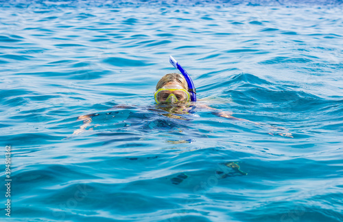snorkeling portrait woman in mask and tube in Red sea water summer vacation activity concept photo