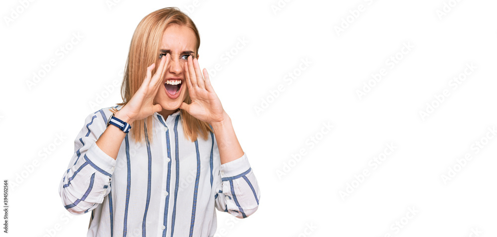 Beautiful caucasian woman wearing casual clothes shouting angry out loud with hands over mouth Beautiful caucasian woman wearing casual clothes shouting angry out loud with hands over mouth