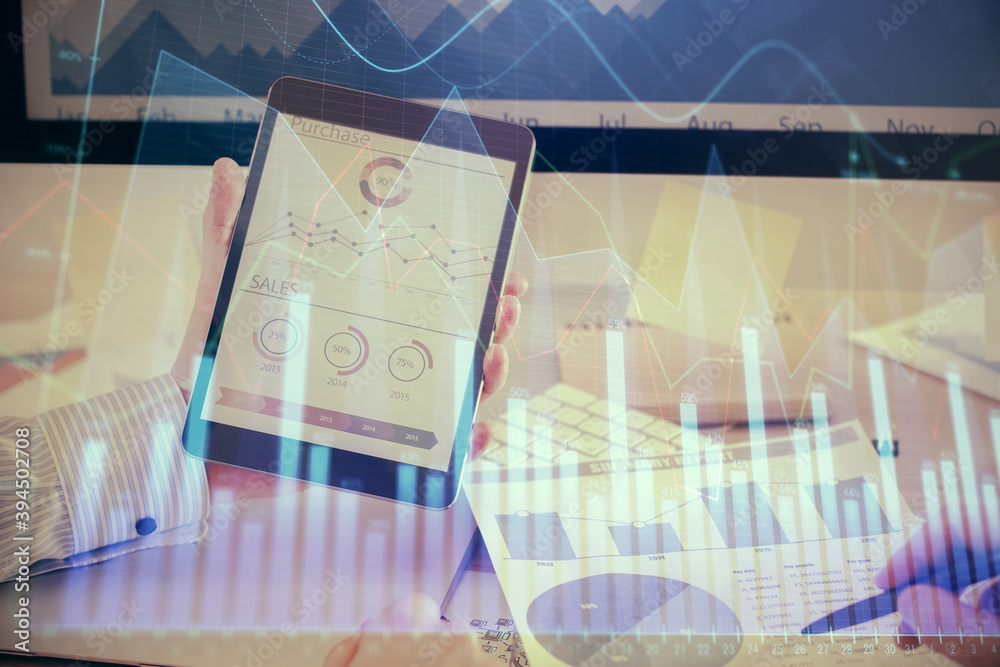 Double exposure of man's hands holding and using a digital device and forex graph drawing. Financial market concept. Double exposure of man's hands holding and using a digital device and forex graph drawing. Financial market concept.