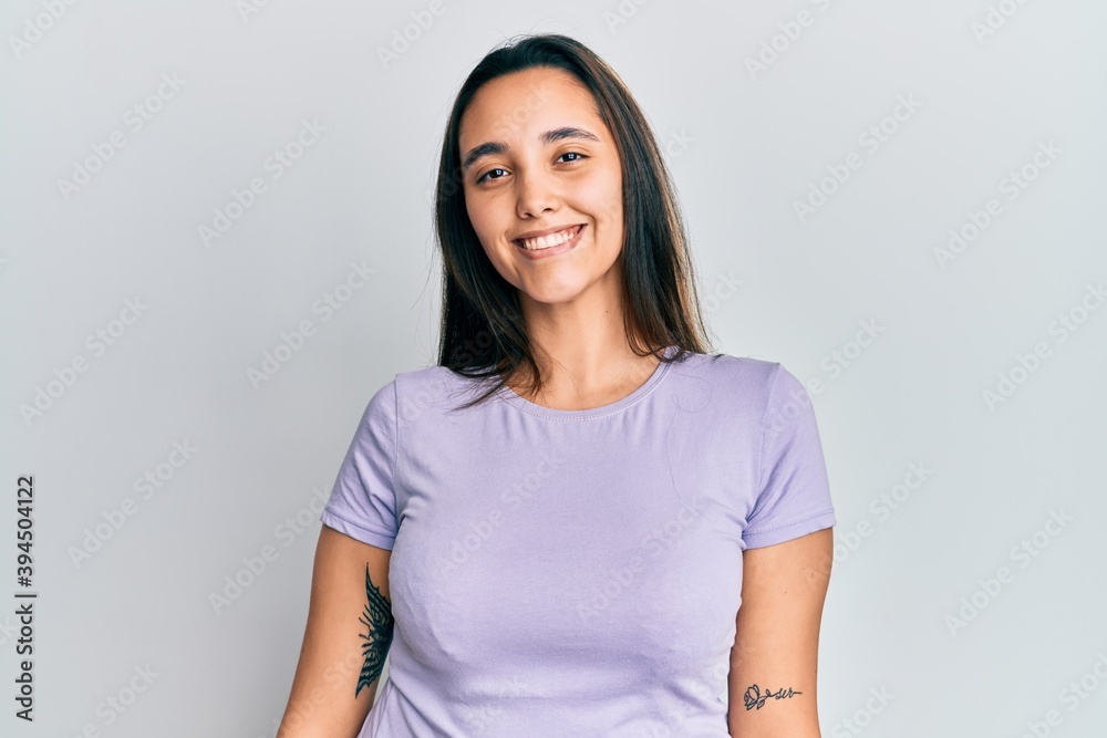 Obraz premium Young hispanic woman wearing casual clothes smiling with an idea or question pointing finger up with happy face, number one