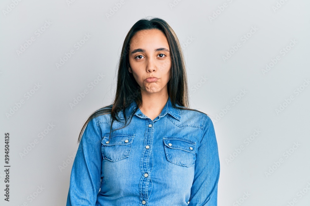 Young hispanic woman wearing casual denim jacket approving doing positive gesture with hand, thumbs up smiling and happy for success. winner gesture. Young hispanic woman wearing casual denim jacket approving doing positive gesture with hand, thumbs up smiling and happy for success. winner gesture.