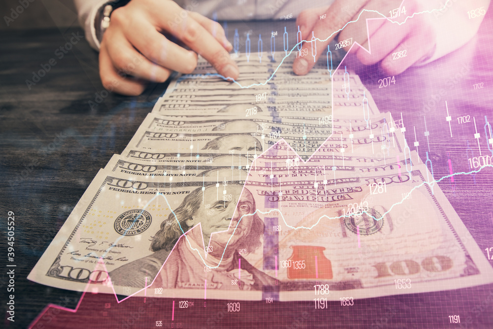 Multi exposure of forex graph drawing hologram and USA dollars bills and man hands. Technical Analysis concept. Multi exposure of forex graph drawing hologram and USA dollars bills and man hands. Technical Analysis concept.