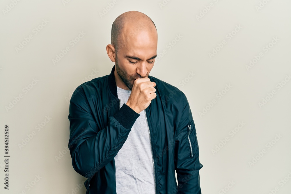 Hispanic bald man wearing casual clothes pointing thumb up to the side smiling happy with open mouth Hispanic bald man wearing casual clothes pointing thumb up to the side smiling happy with open mouth