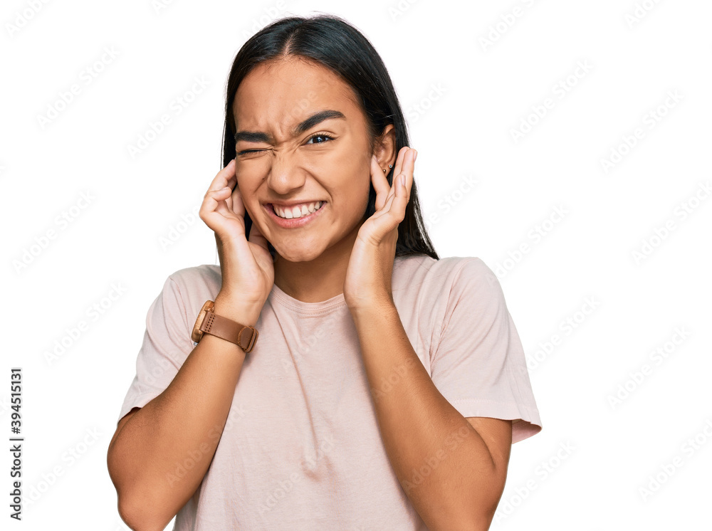 Young asian woman wearing casual clothes covering ears with fingers with annoyed expression for the noise of loud music. deaf concept. Young asian woman wearing casual clothes covering ears with fingers with annoyed expression for the noise of loud music. deaf concept.