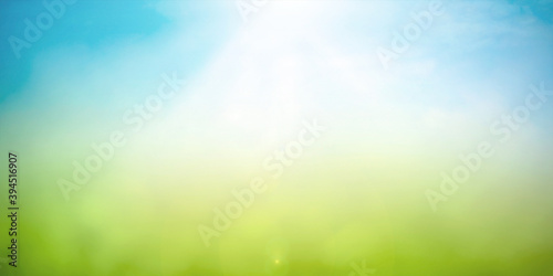 World environment day concept: Abstract blurred beautiful green bokeh light meadow and blue sky on autumn sunrise background