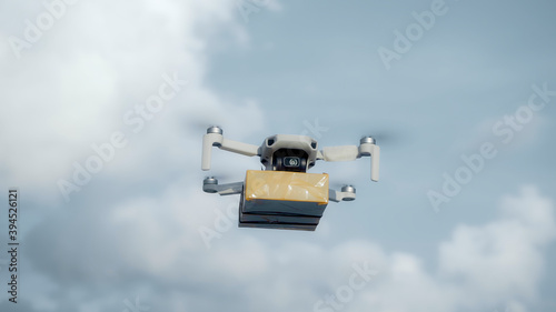 flying on a sky delivery drone with holding a .cardboard parcel