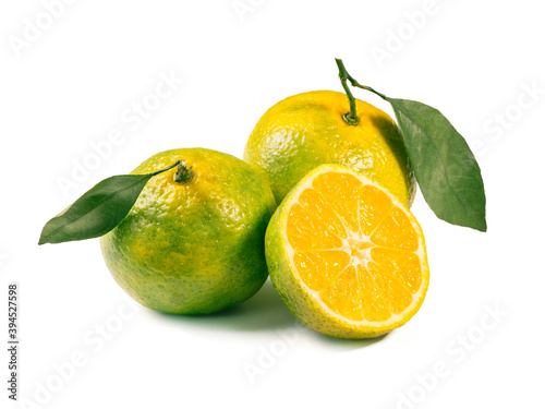 Green mandarines isolated on white background. Perfect fresh ripe green tangerines with leaves and half tangerin isolated on white with clipping path.