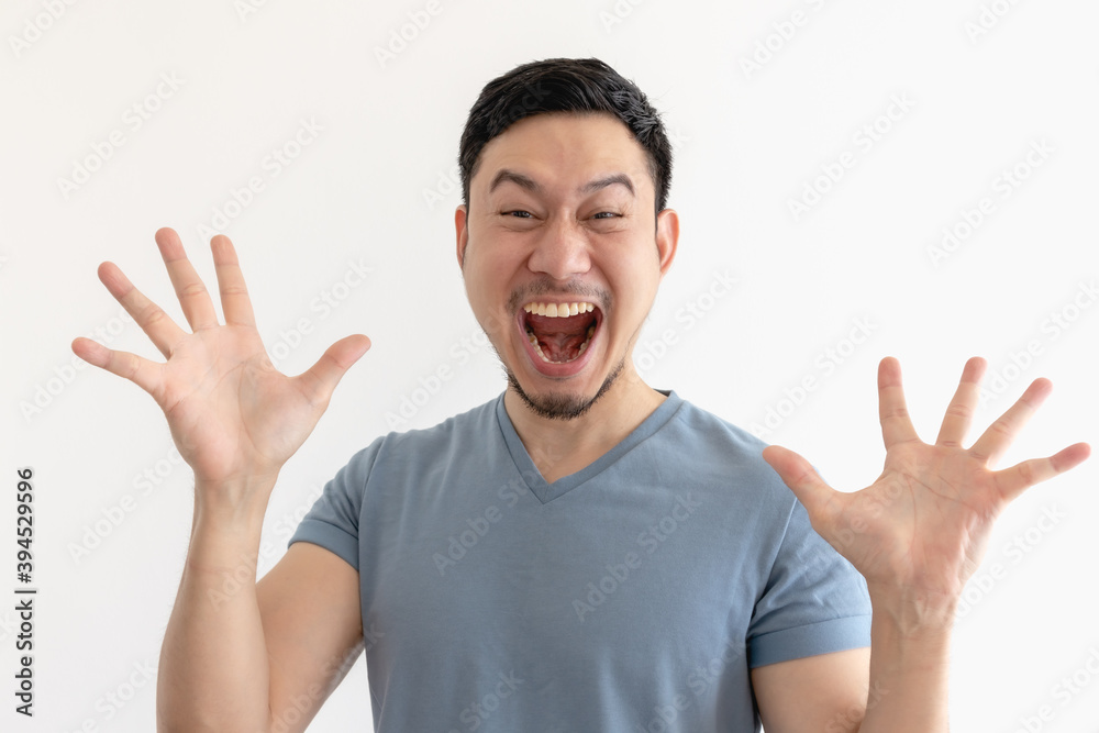 Surprised and wow face of Asian man in blue t-shirt on isolated background. Surprised and wow face of Asian man in blue t-shirt on isolated background.