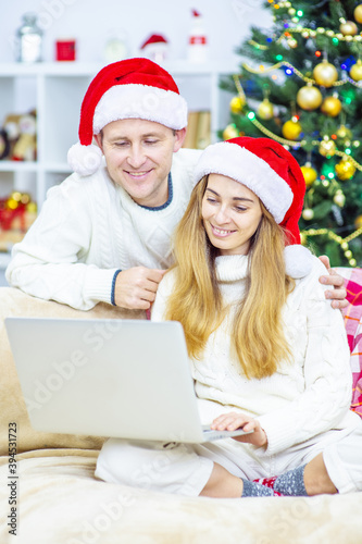Cute family saying hello to some relatives while doing a video call on Christmas Eve
