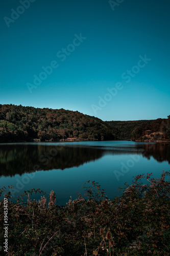 Mystic reflections in the lake. Bozcaarmut lake in Bilecik Turkey in the autumn. Vertical landscape.