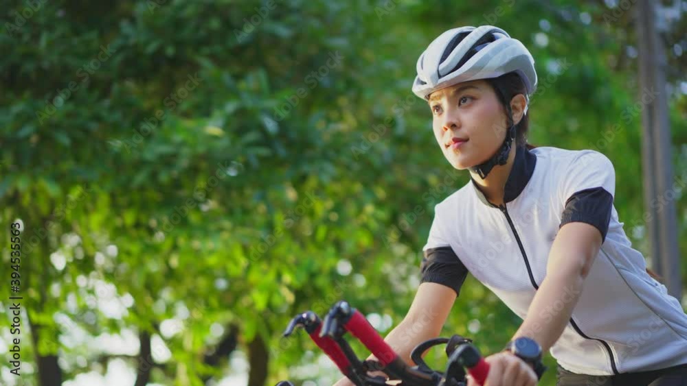 Asian young beautiful woman riding bicycle for excercise in the park. Asian young beautiful woman riding bicycle for excercise in the park.